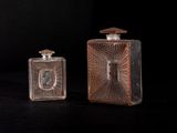 pair of antique glass perfume bottles on a black background