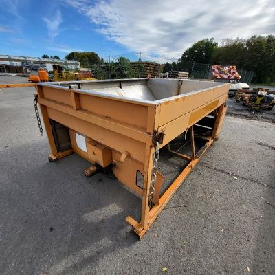 a close up of a metal trough on a parking lot