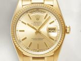 an image of a gold rolex watch sitting on a white surface