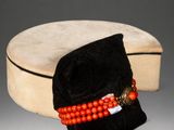 an old hat with a red beaded band and a black velvet bag