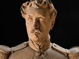 a statue of a man in a uniform with a flower on his chest
