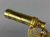an antique brass telescope with a brass handle on a white background
