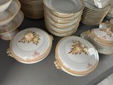 a lot of plates and bowls on the table