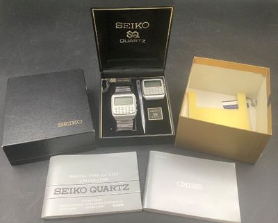 a box that has a cell phone and a pen in it