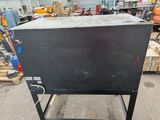 a black box sitting on top of a cart in a warehouse