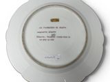 a white plate with a picture on it on a white surface