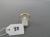 a ring with a price tag on it sitting on a table