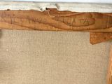 a piece of wood that has writing on it