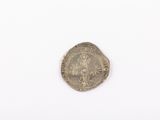 an old silver coin with a crown on it on a white surface