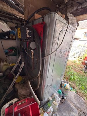 an image of a garage with a washing machine and tools