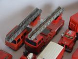 a lot of toy firetrucks and trucks on the table