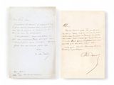 an old book with a handwritten letter on it sitting on top of a table