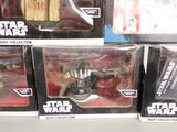 several star wars action figures are on display in a store