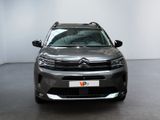 the front of a grey citrole parked in a white room