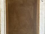 an old picture frame sitting on top of a wooden floor next to a wall