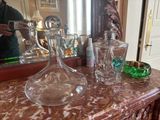 a man taking a picture of a glass decanter on a table