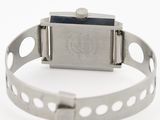 a watch that is on a bracelet on a white surface