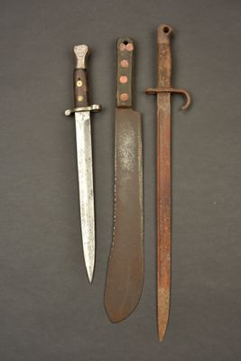 two knives are sitting next to each other on a table