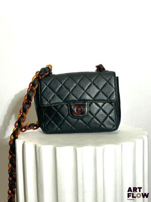 a small black purse sitting on top of a radiator