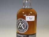 a bottle of whisky sitting on top of a white table