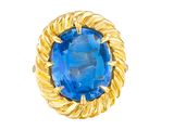 a close up of a ring with a blue stone in it