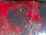a red and black painting on the wall of a building