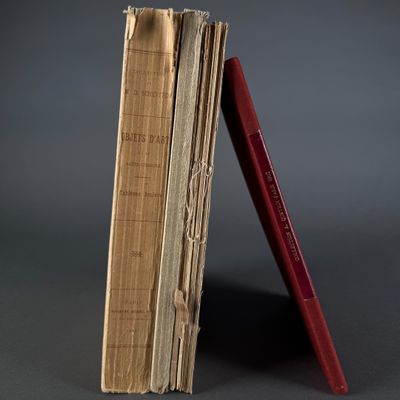 a red pencil sticking out of a stack of old books