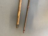 two pencils that are sitting next to each other on a table