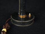 an image of a black and gold lamp on a black background