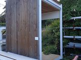 a picture of a building with a lot of wood on the ground