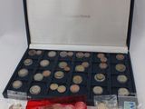 a box of coins and a plastic container with coins in it