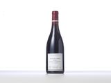a bottle of red wine sitting on top of a table