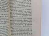 an open book with a black and white image of a cat