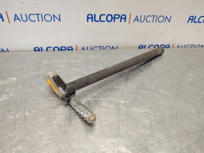 a large metal hammer on a table with a sign in the background