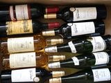 many bottles of wine in a box on the table