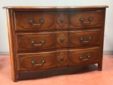 a wooden dresser with many drawers on top of it