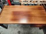 an image of a wooden table in a warehouse