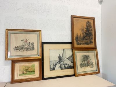 many framed pictures on a shelf in a room