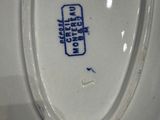 a close up of a white porcelain toilet with a blue lid