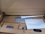 a person opening a cardboard box with a bunch of items in it