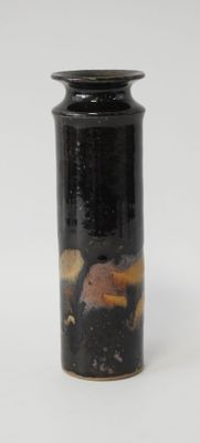 un vase noir orné d'un motif marron et jaune