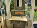 a bathroom with a sink, mirror and rug in it