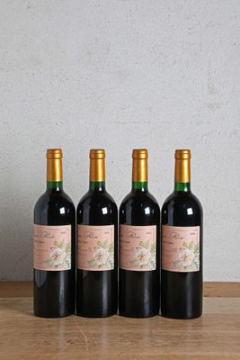 four bottles of wine sitting on a wooden table next to a bottle of wine