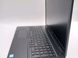 a laptop computer sitting on a table with a keyboard
