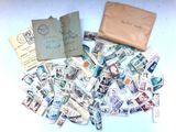 a lot of stamps on the table next to a wallet