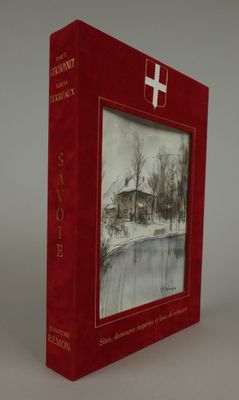 a red book with a picture of a house in the background