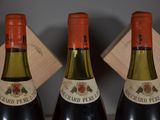 three bottles of wine that are sitting on a table