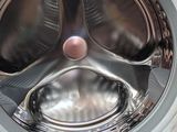 a close up of a washing machine with the door open