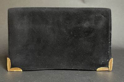 a black leather wallet with gold accents on a table