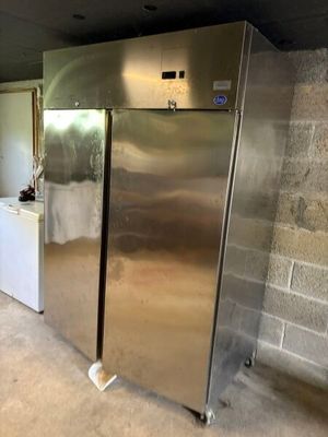 a large stainless steel refrigerator in the middle of a room